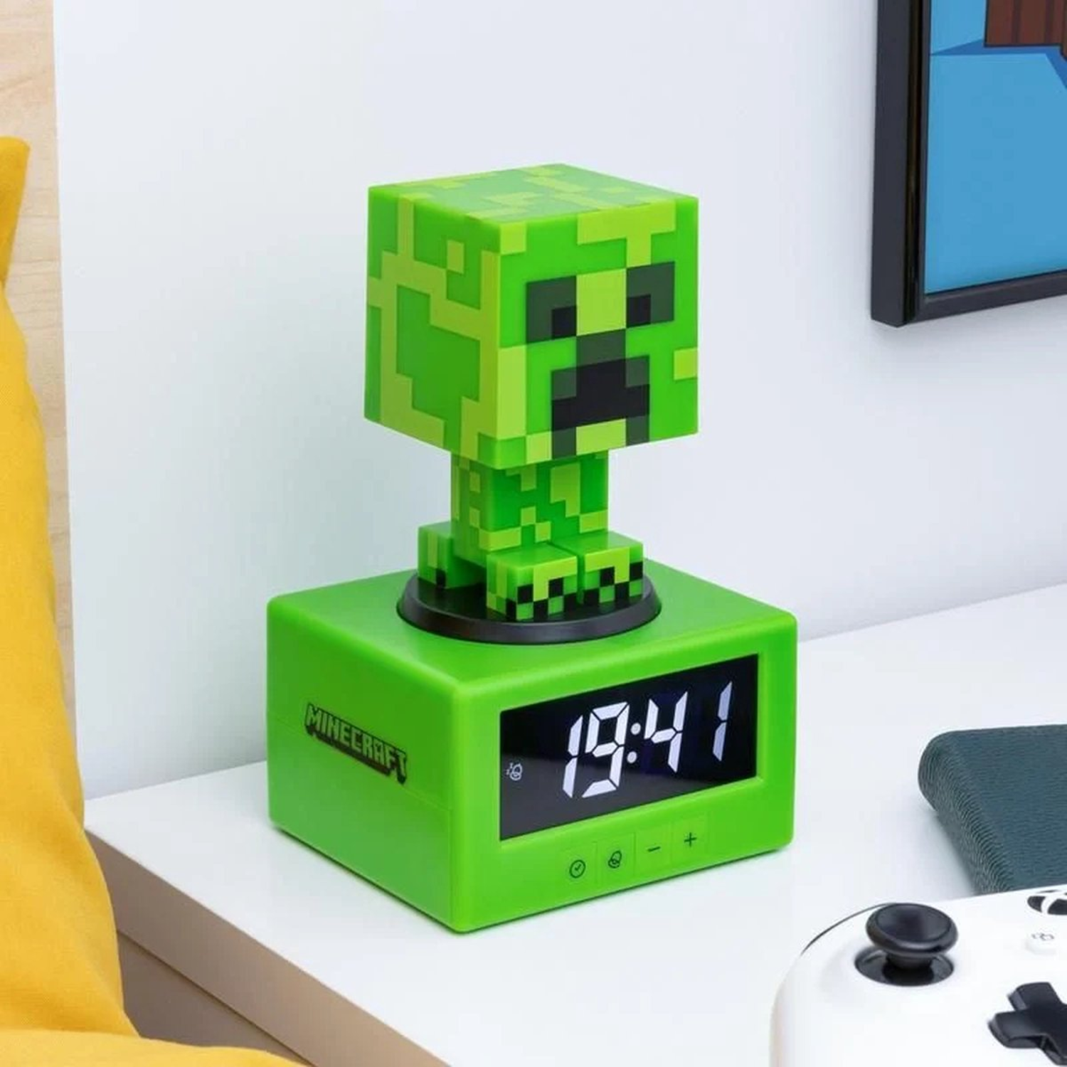 Green Minecraft alarm clock displays 19:41, with Creeper head on top. White controller nearby.