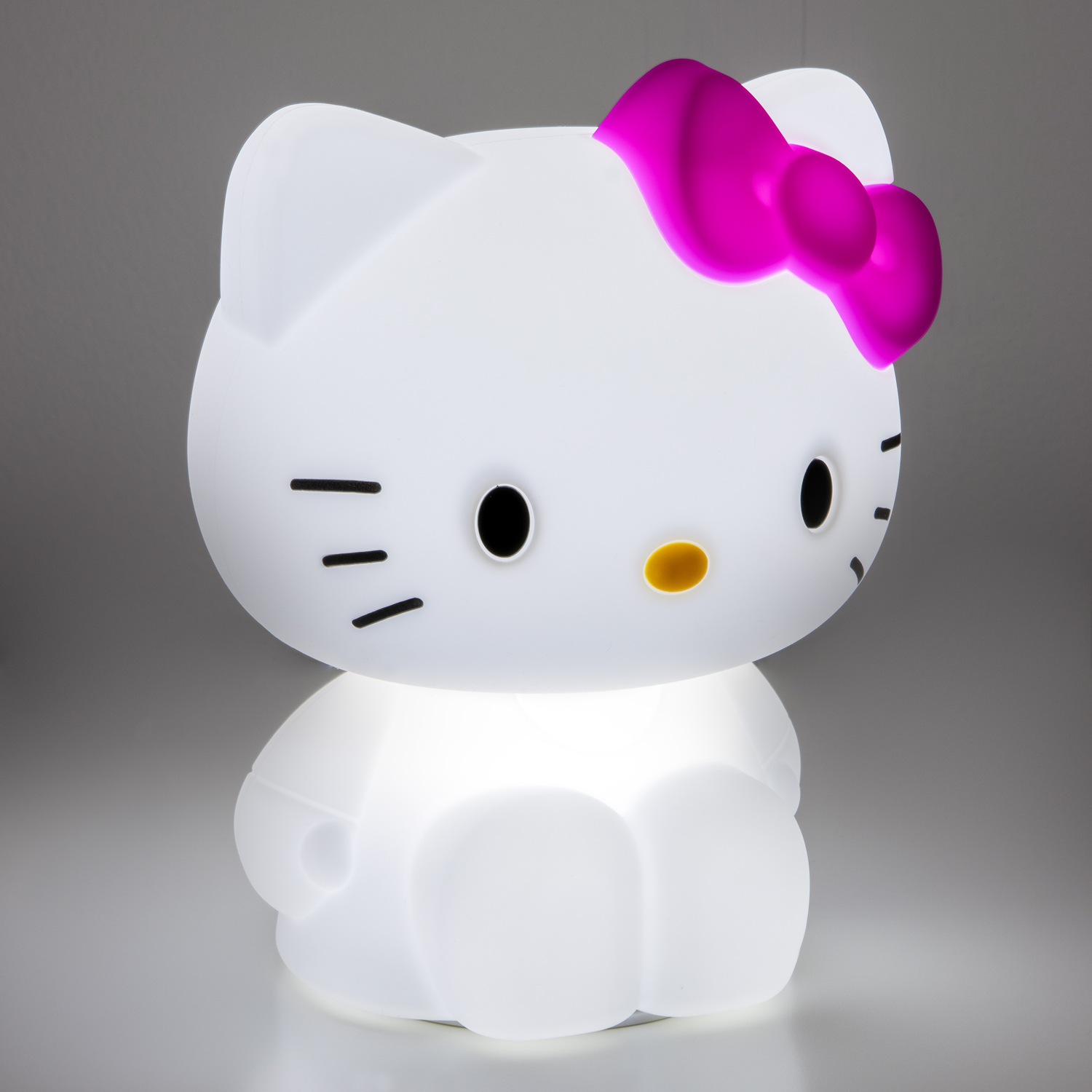 Hello Kitty lamp. White body, pink bow, black eyes, and yellow nose. Light emitting.