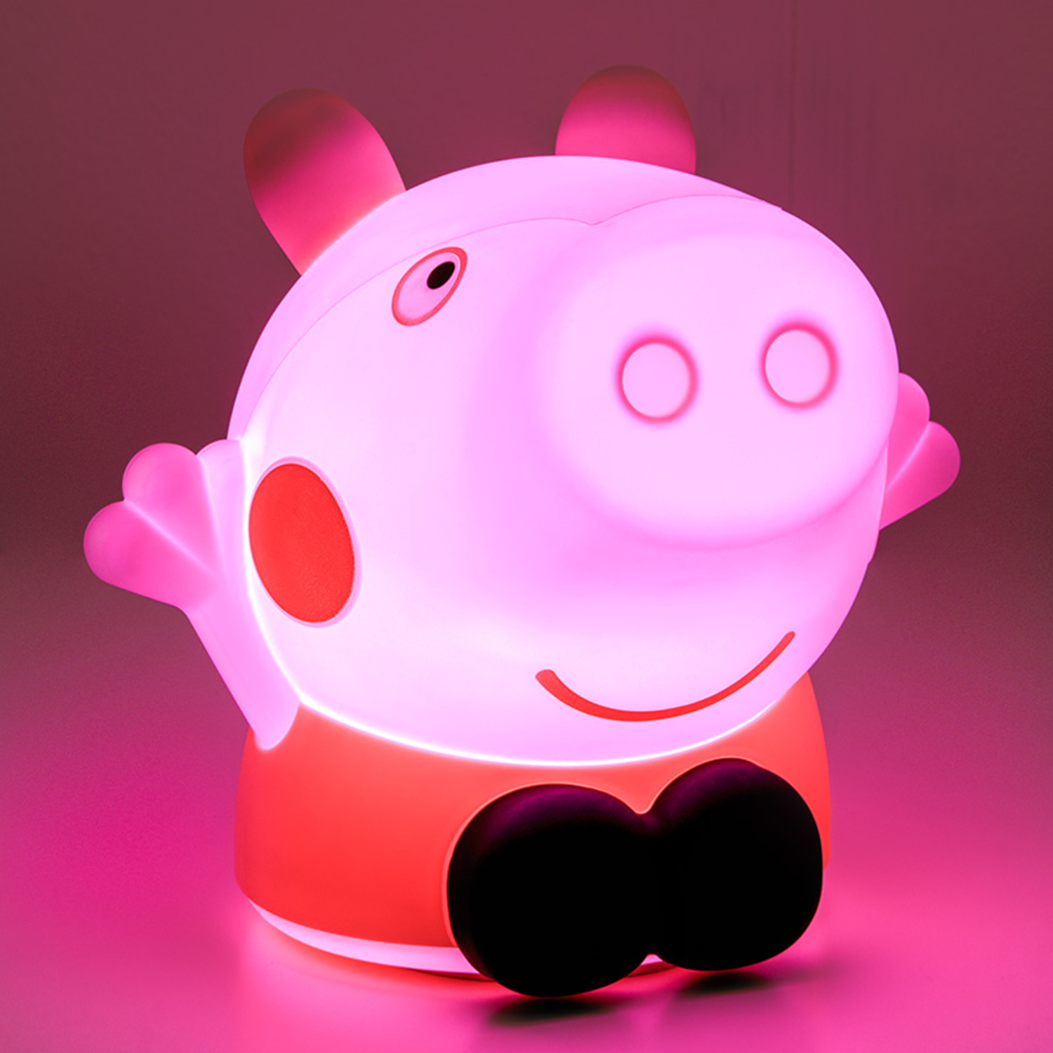 A Peppa Pig night light glowing pink. The character is smiling.
