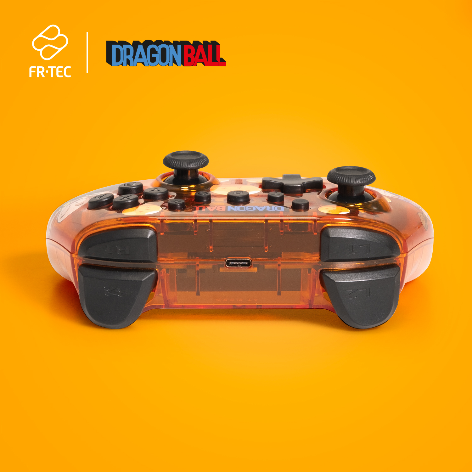 Oranger Dragon Ball Controller mit schwarzen Knöpfen und durchsichtigem Kunststoff auf orangefarbenem Hintergrund.
