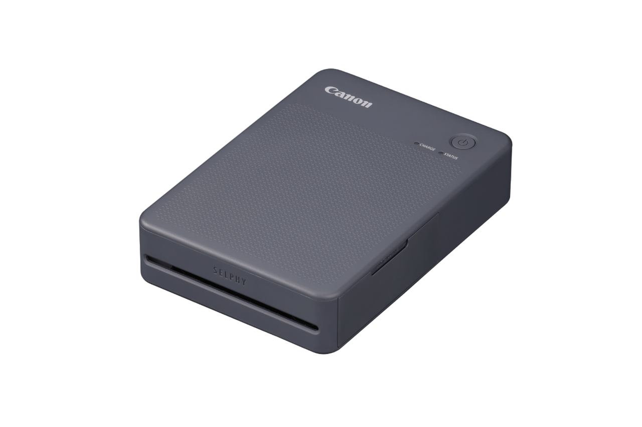 Dunkelgrauer Canon Selphy Fotodrucker. Oben Logo und Statustaste.