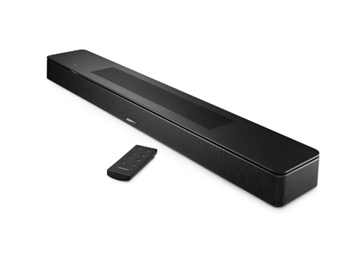 Barra de sonido Bose negra con mando a distancia sobre superficie blanca, minimalista.