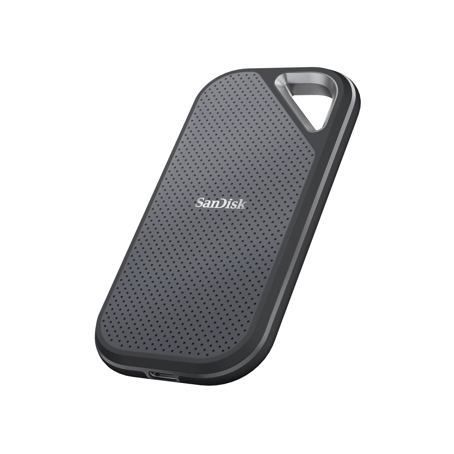 Un disco duro portátil SanDisk gris sobre un fondo blanco, con un lazo plateado.