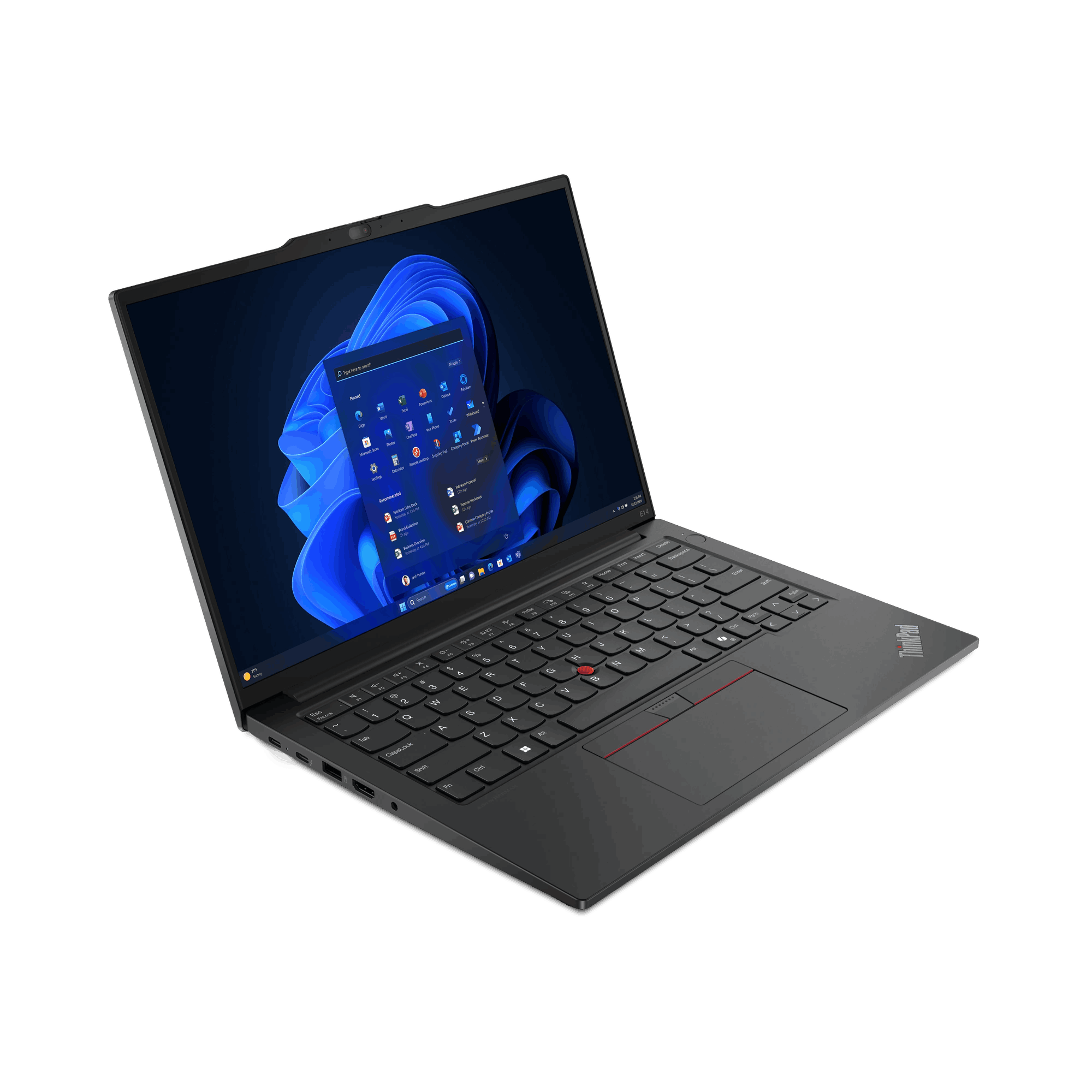 Una computadora portátil negra sobre una superficie oscura, abierta con una pantalla iluminada.