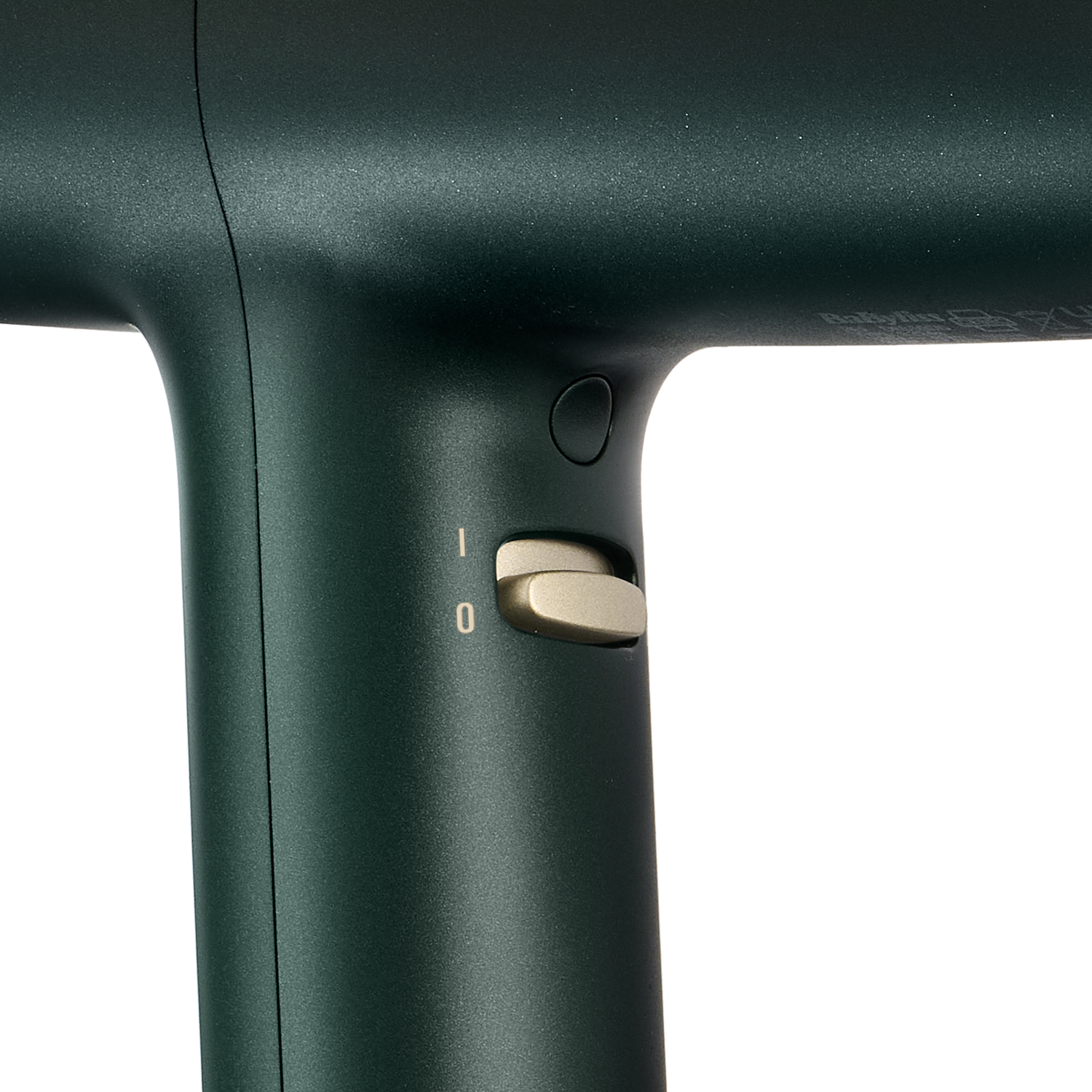 Close-up of a dark green hairdryer with an on/off switch.