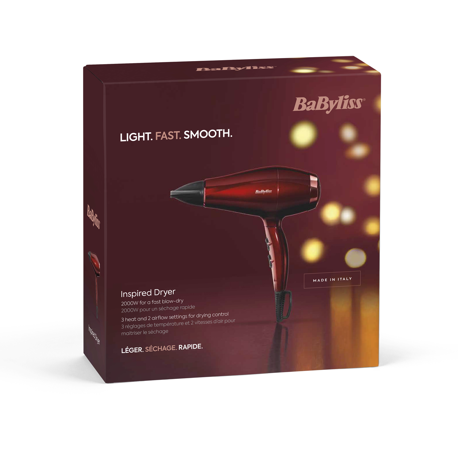 A red and black hair dryer in its box. The box has text that says 'LIGHT. FAST. SMOOTH'.
