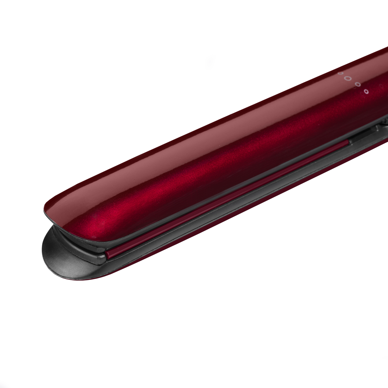 Close-up of a red hair straightener, angled against a white background, showing the iron plates.