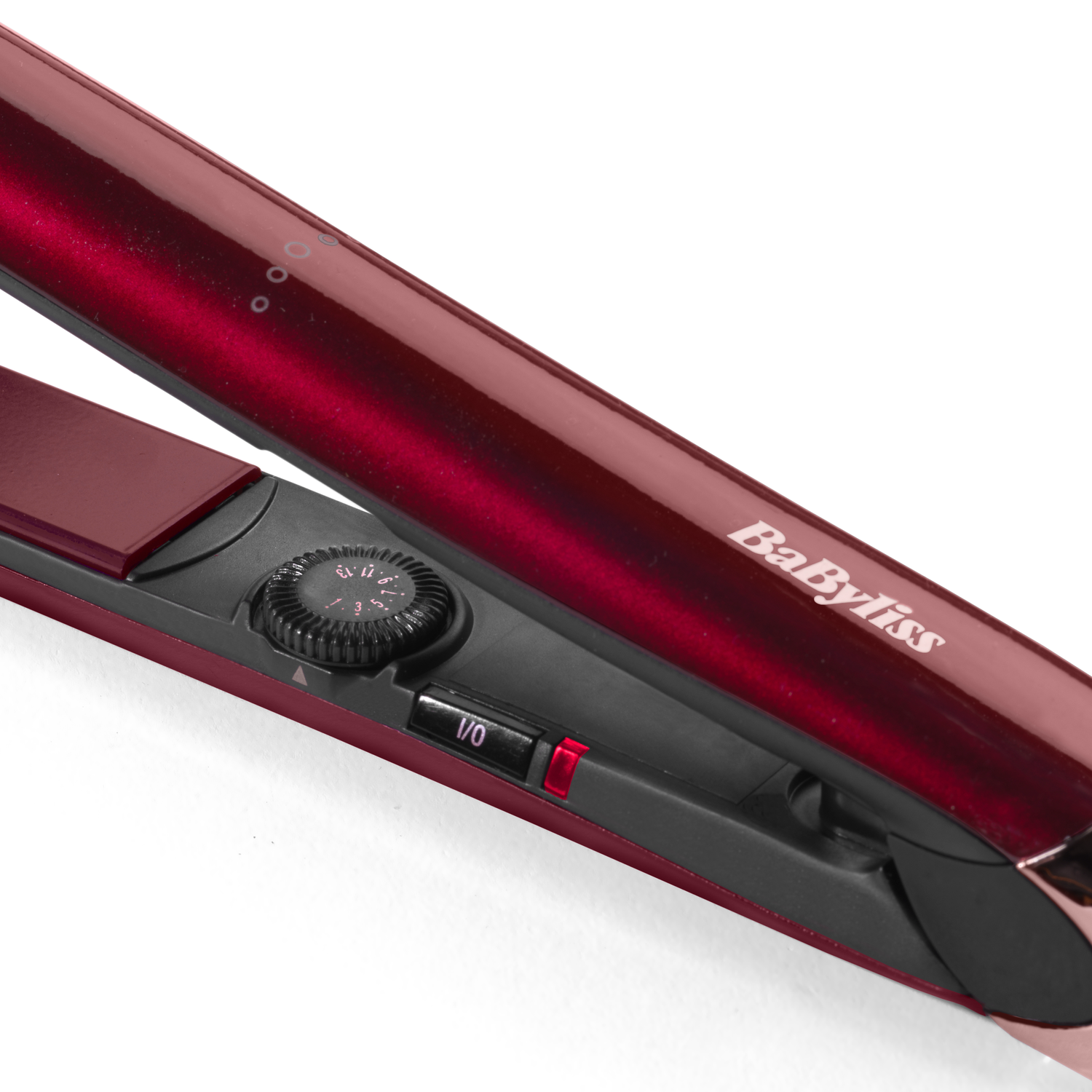 A red hair straightener is on a white background. The brand is BaByliss.