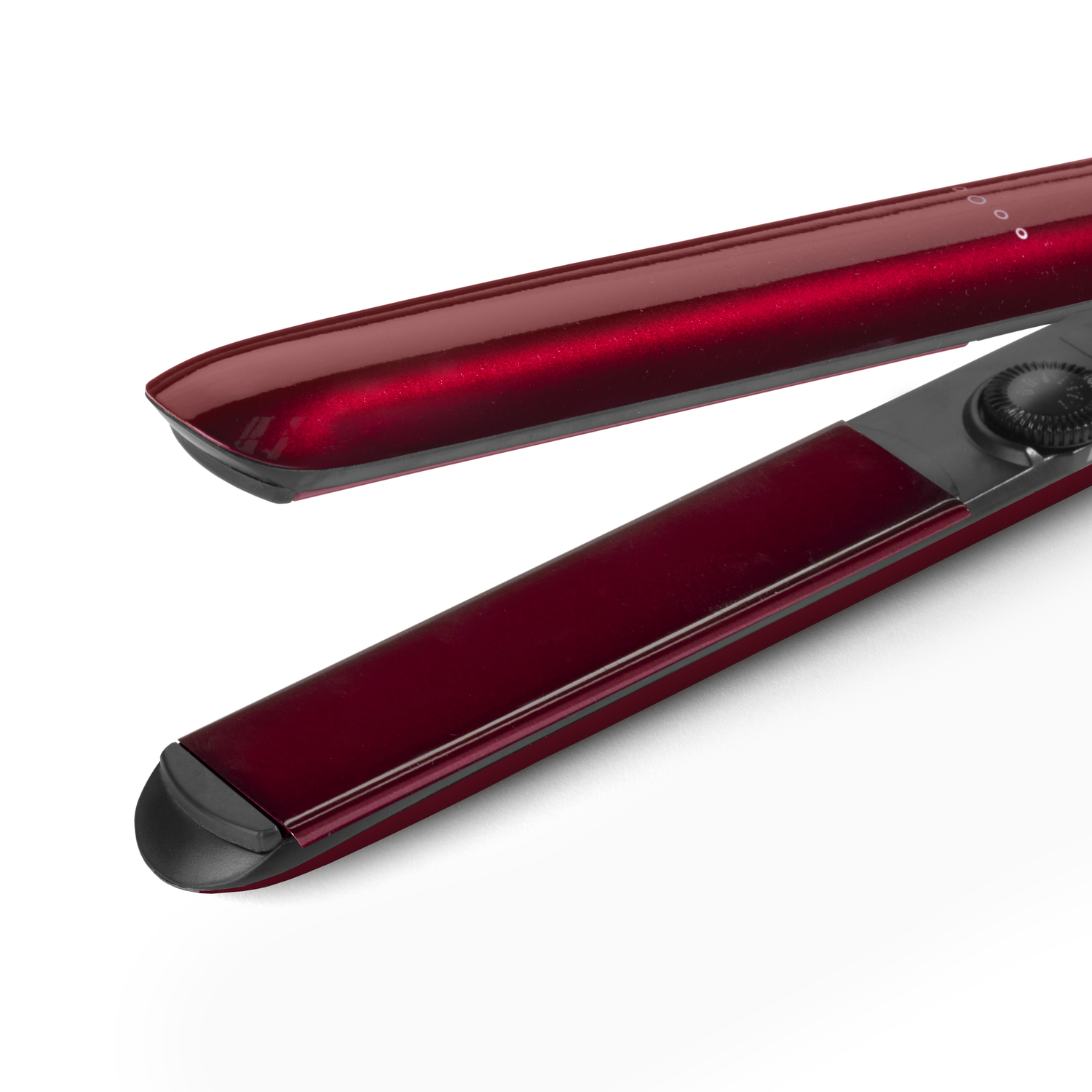 Close-up of a red hair straightener. The device is open, showing heated plates.
