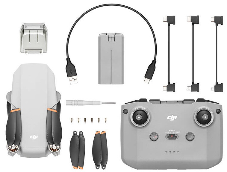 Zestaw drona z dronem, pilotem, baterią, kablami i akcesoriami. Biały dron z pomarańczowymi akcentami.