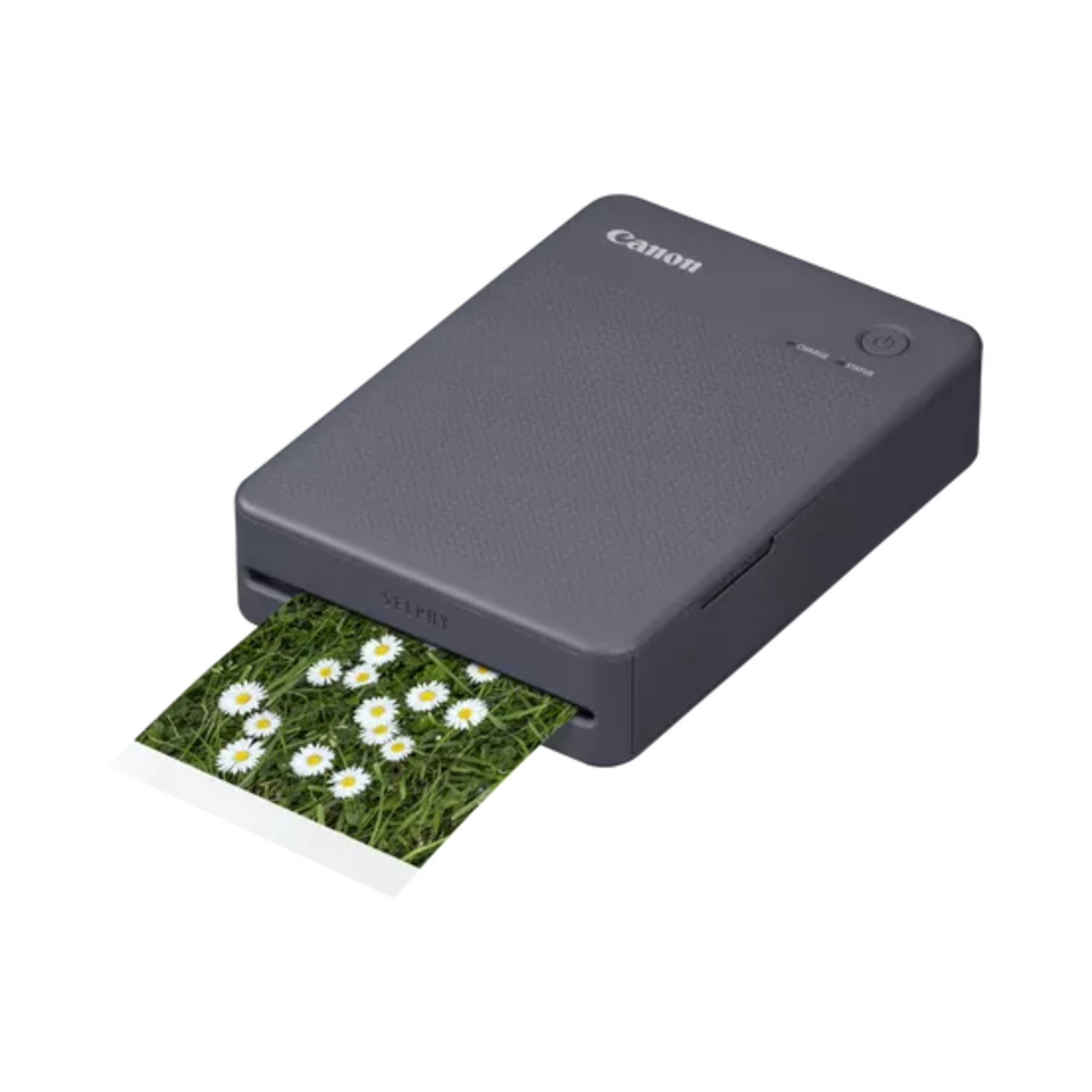 A gray Canon Selphy photo printer printing a photo of daisies.