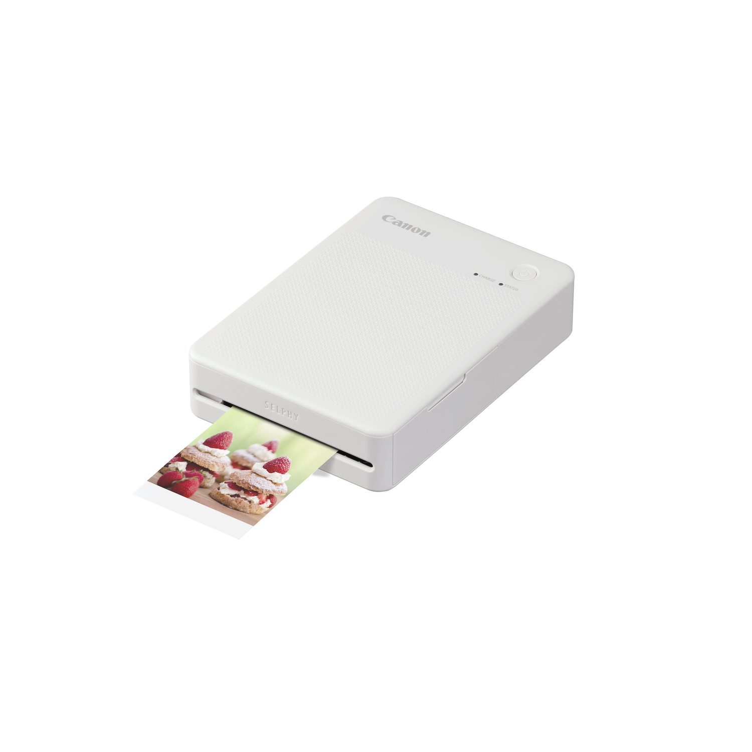 White portable photo printer printing a photo of a cake with strawberries.