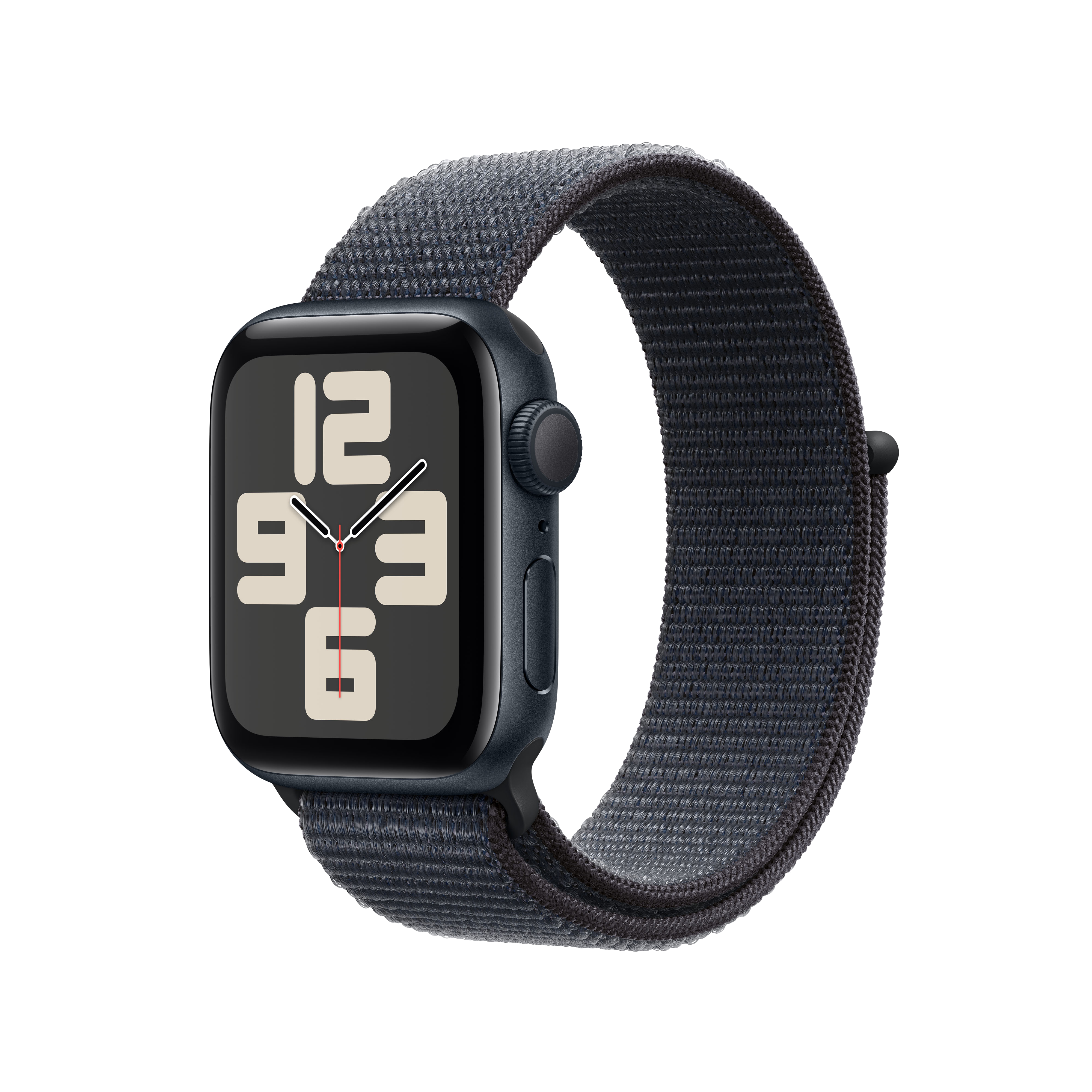 Apple Watch negra con correa de tela azul oscuro. La pantalla muestra la hora: 12:00:06.