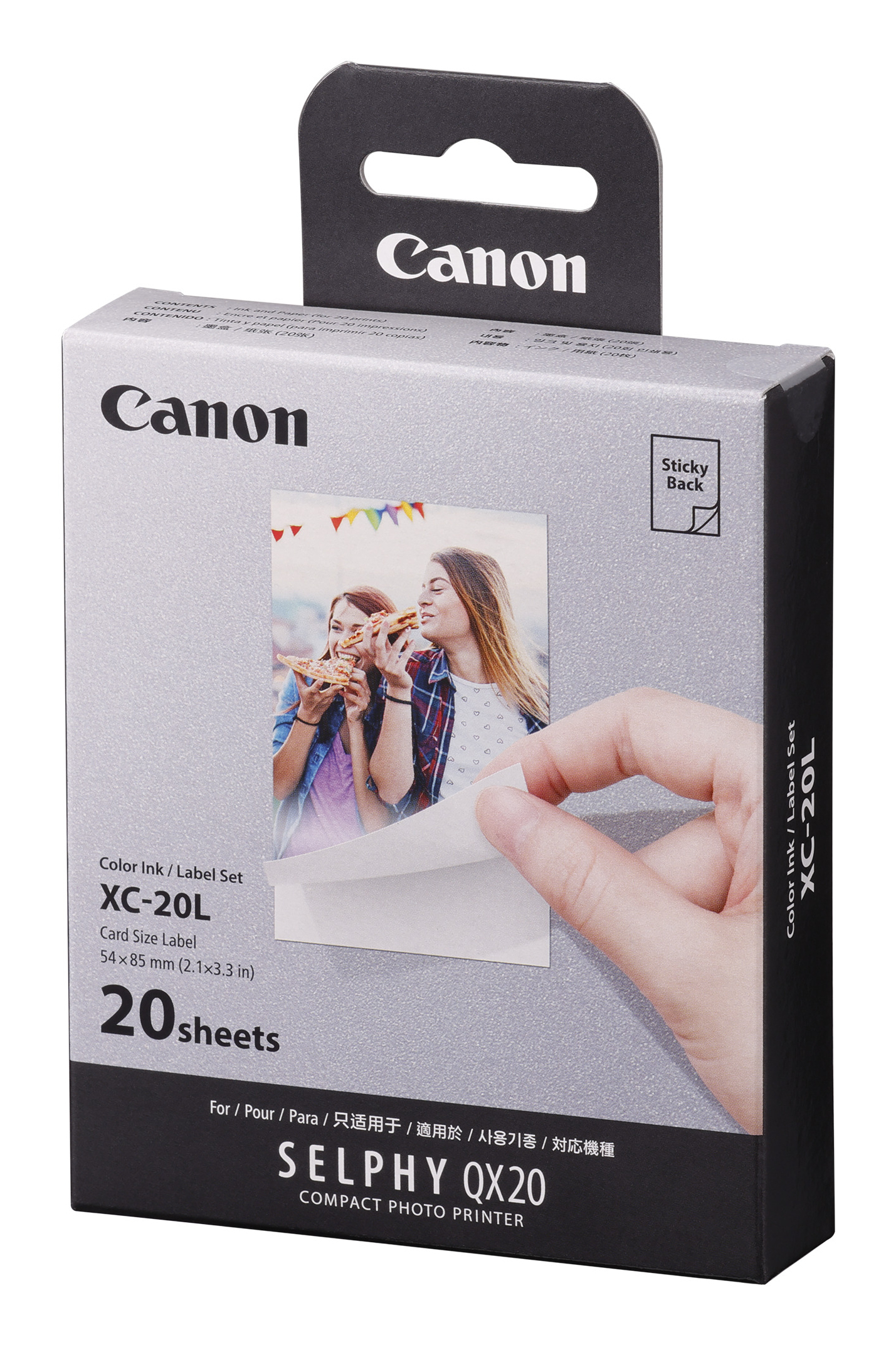 Canon Fotopapierbox. Eine Hand nimmt ein Foto heraus. Zwei Frauen sind auf dem Foto.