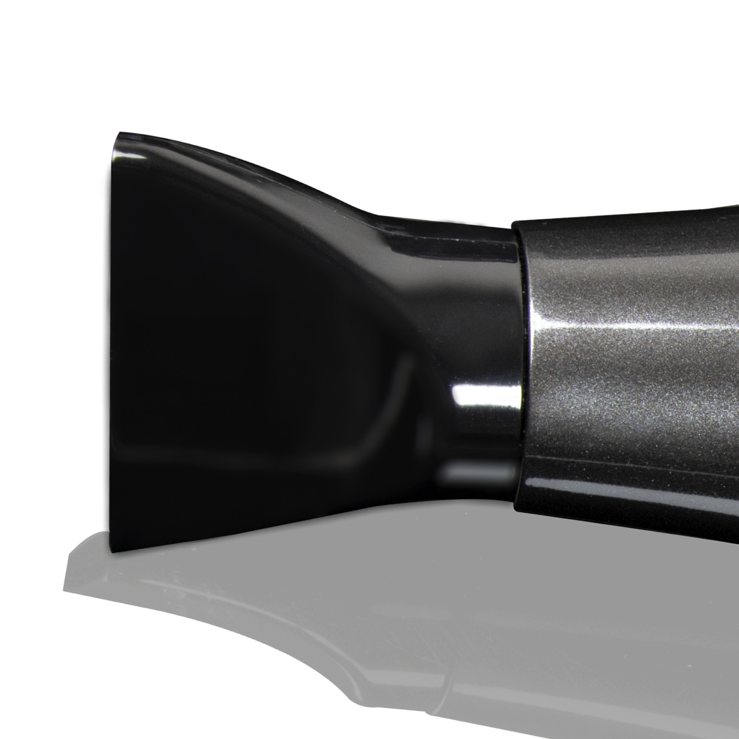 Close up of a black hair dryer nozzle, white background, with a slight shadow.
