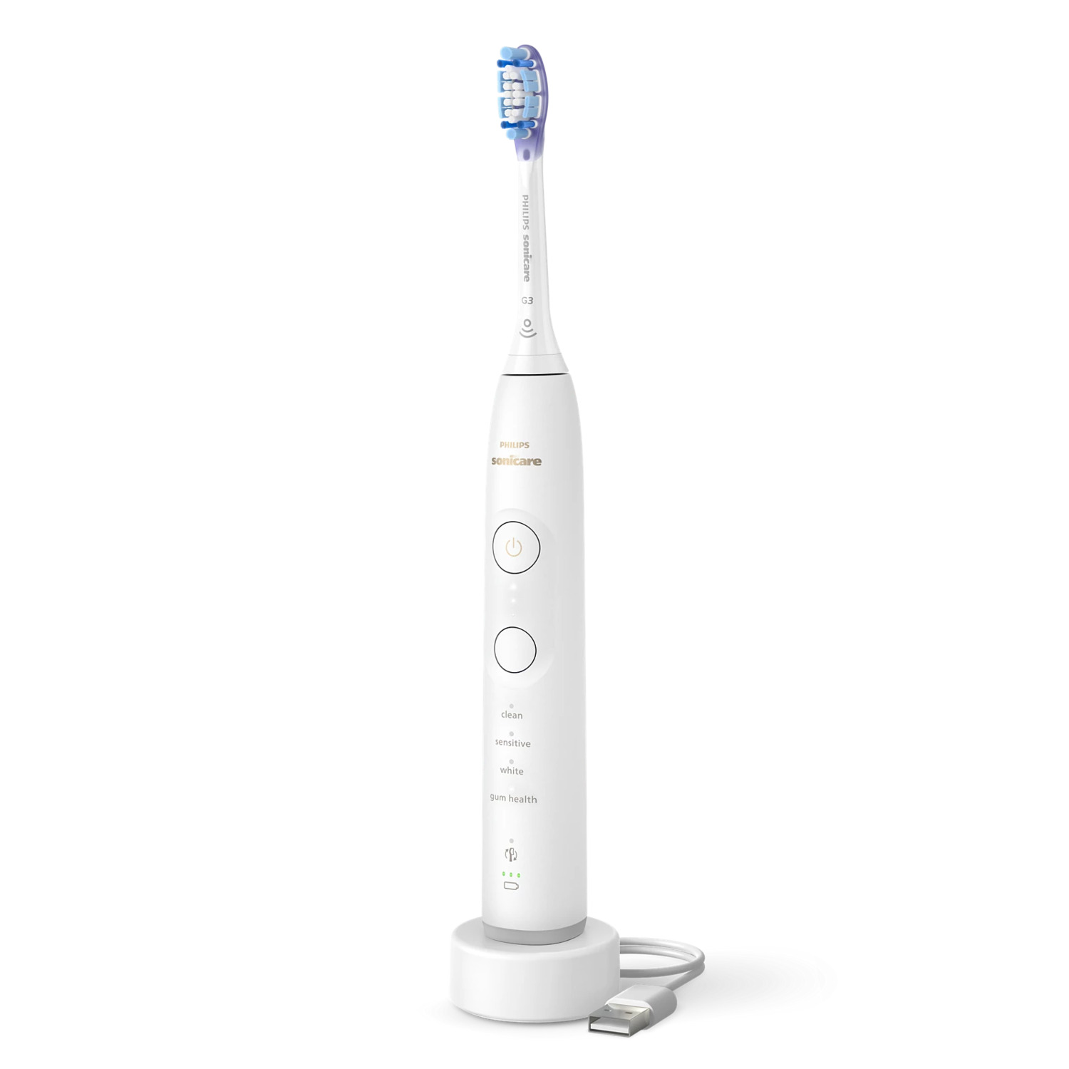 Une brosse à dents électrique blanche sur une base de chargement blanche. Elle a une tête bleue et violette.