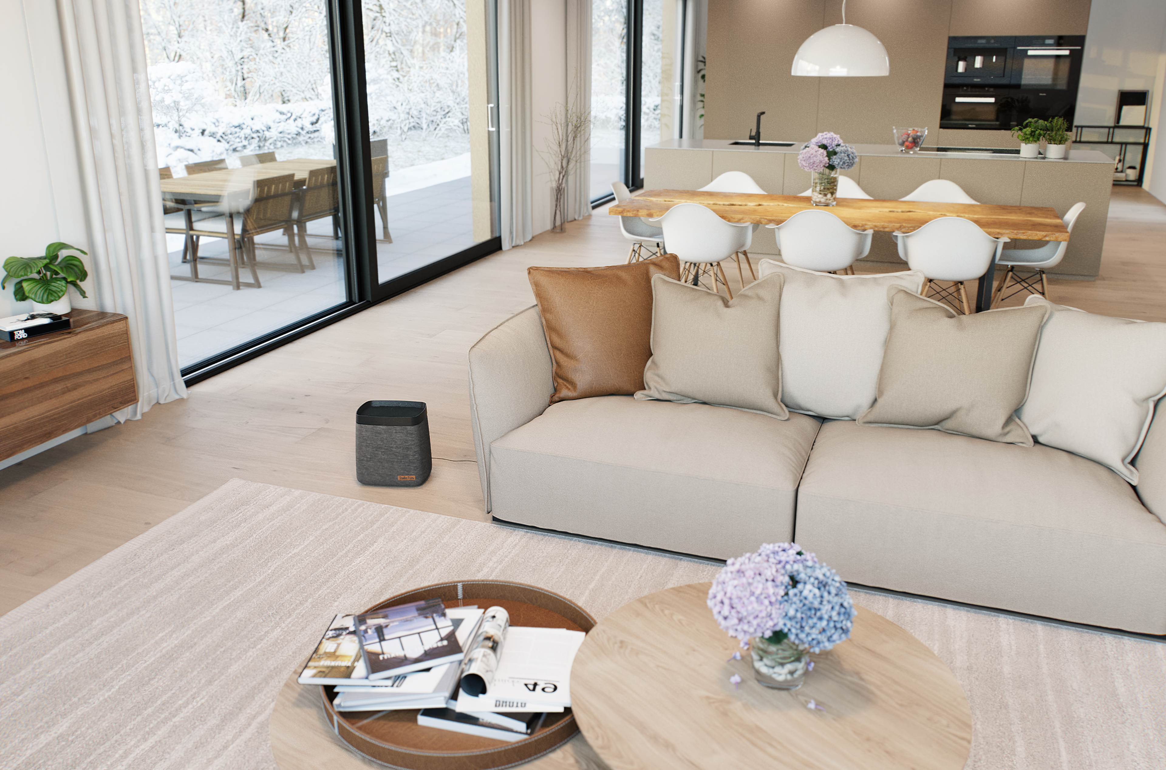Ein modernes Wohnzimmer mit Couch, Couchtischen und Blick nach draußen.