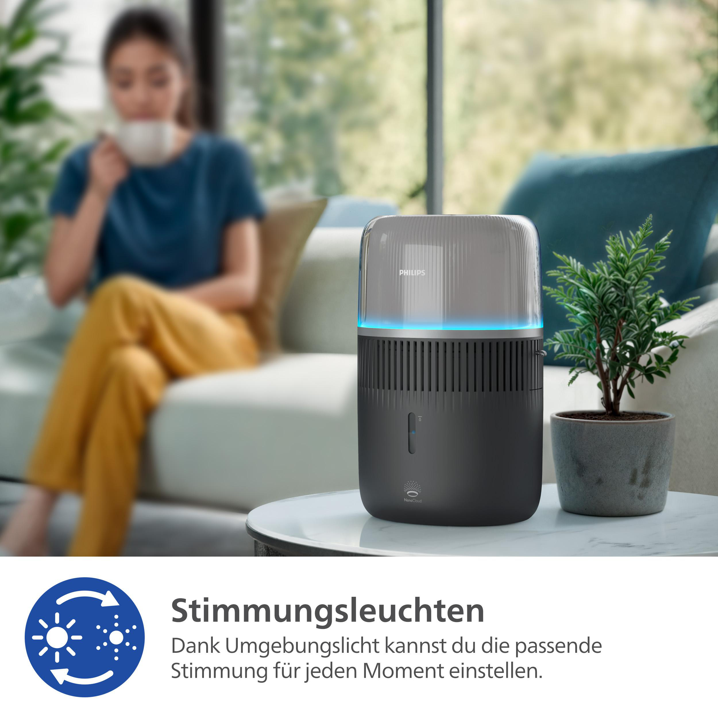Luftreiniger auf Tisch, Frau im Hintergrund. Text: 'Stimmungsleuchten'.