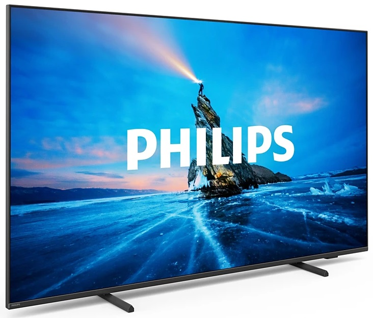 Telewizor Philips z lodowatym krajobrazem na ekranie, osoba zapala pochodnię. Ciemna ramka, niebieskie niebo.