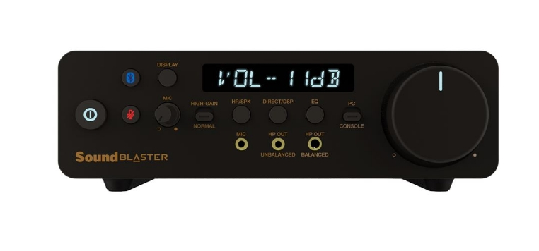 Czarne urządzenie audio Sound Blaster z wyświetlaczem głośności, pokrętłem i kilkoma przyciskami.