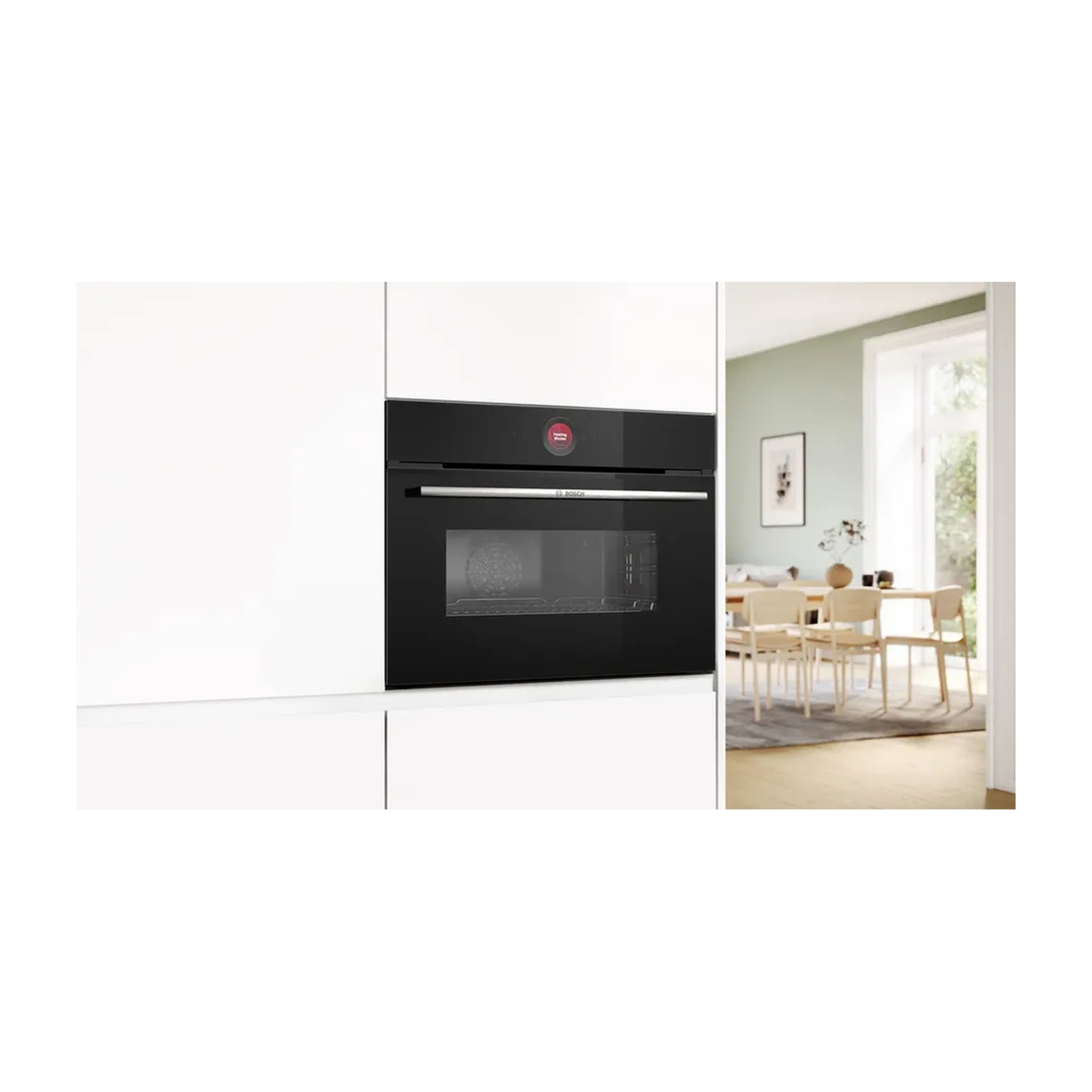 Forno nero a incasso in una cucina bianca. La porta del forno è chiusa, pulsante rosso visibile.