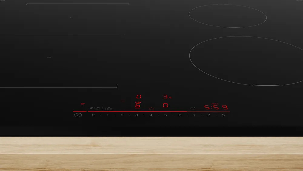 Czarna płyta indukcyjna z wyświetlaczem cyfrowym. Posiada przyciski sterowania i czerwone podświetlane cyfry.