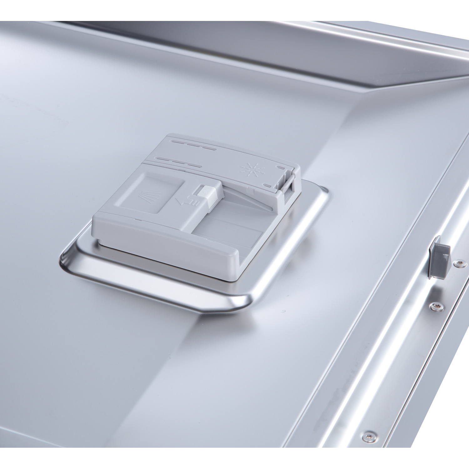 A close-up of a dishwasher detergent dispenser.