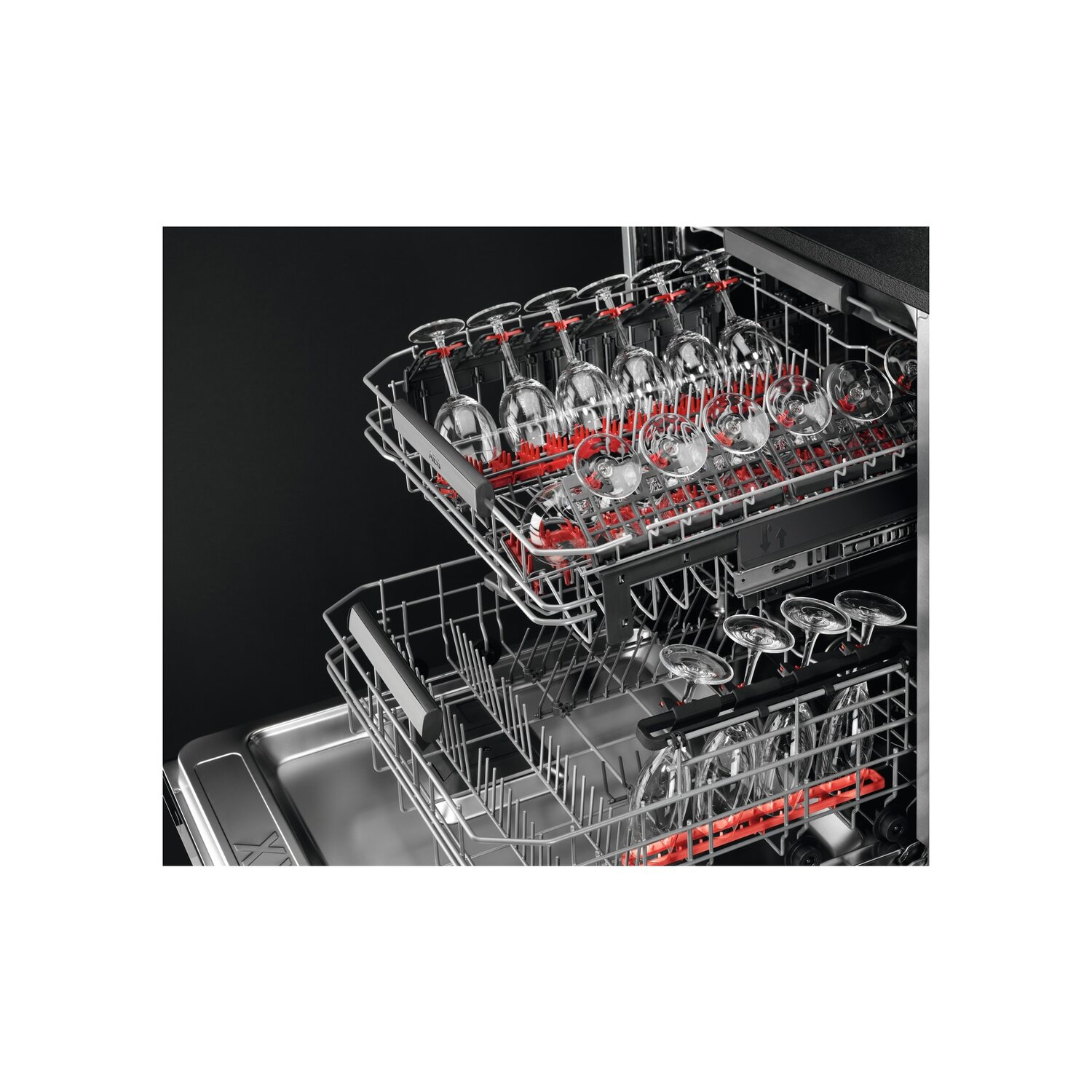 Dishwasher interior with glasses in racks, black background.