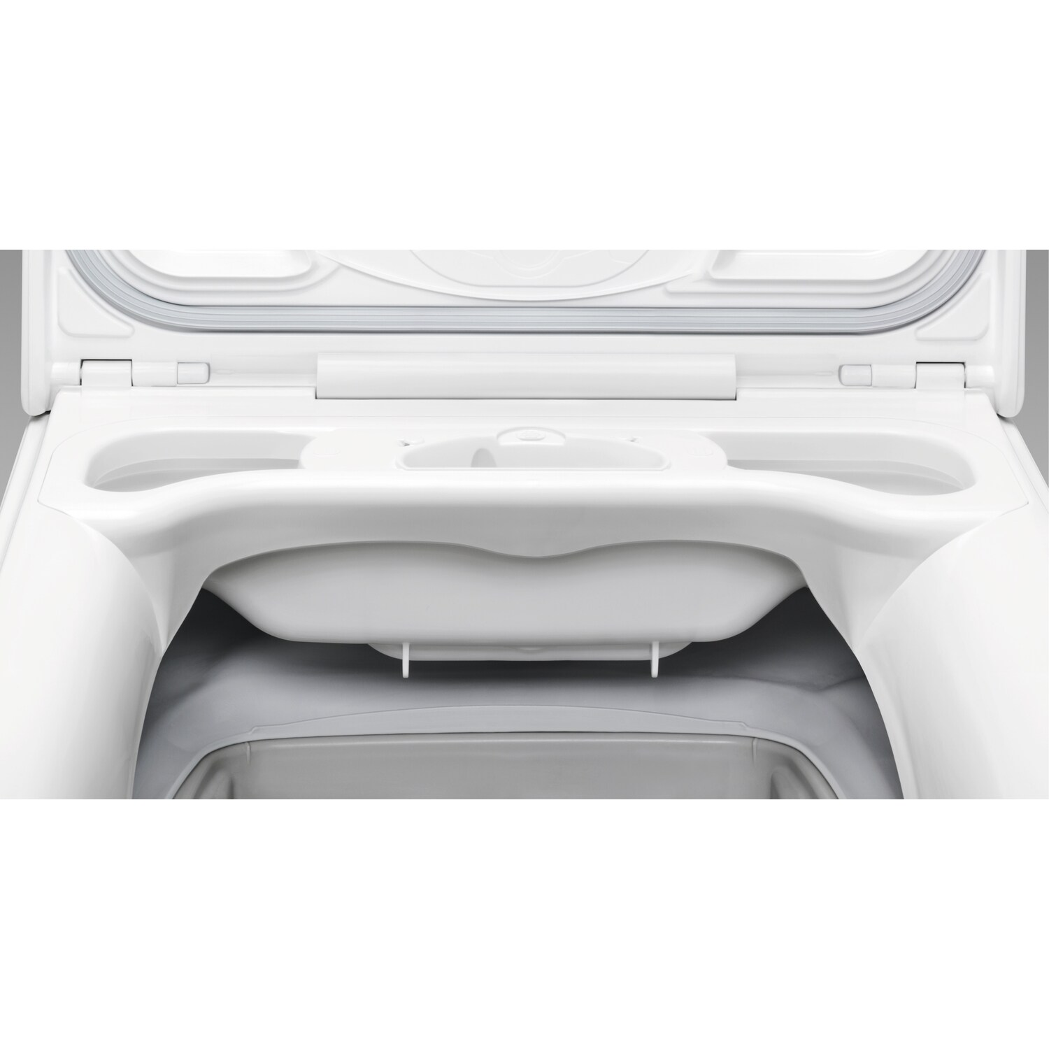 Inside of a white washing machine, showing the detergent tray.