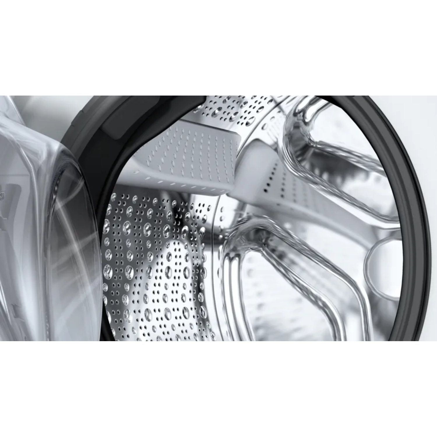 Close-up of a washing machine drum, showing the interior with water droplets.