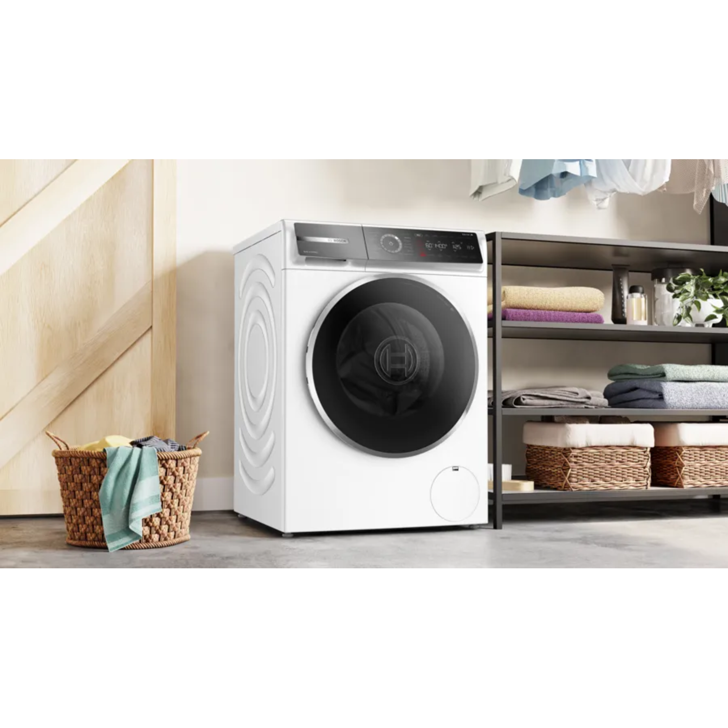 White washing machine with laundry basket and shelves in a laundry room. The machine is on.