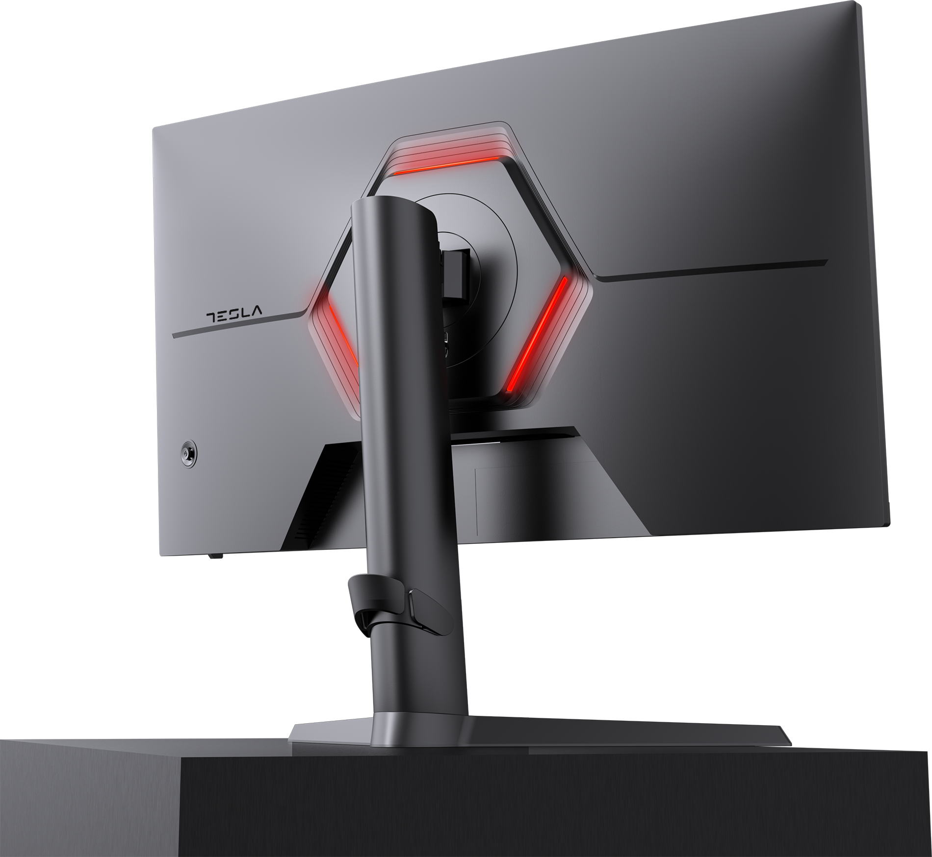 Egy fekete monitor hátulja, piros fénnyel világító hexagonnal. A monitor sötét felületen áll. Tesla logó látható.