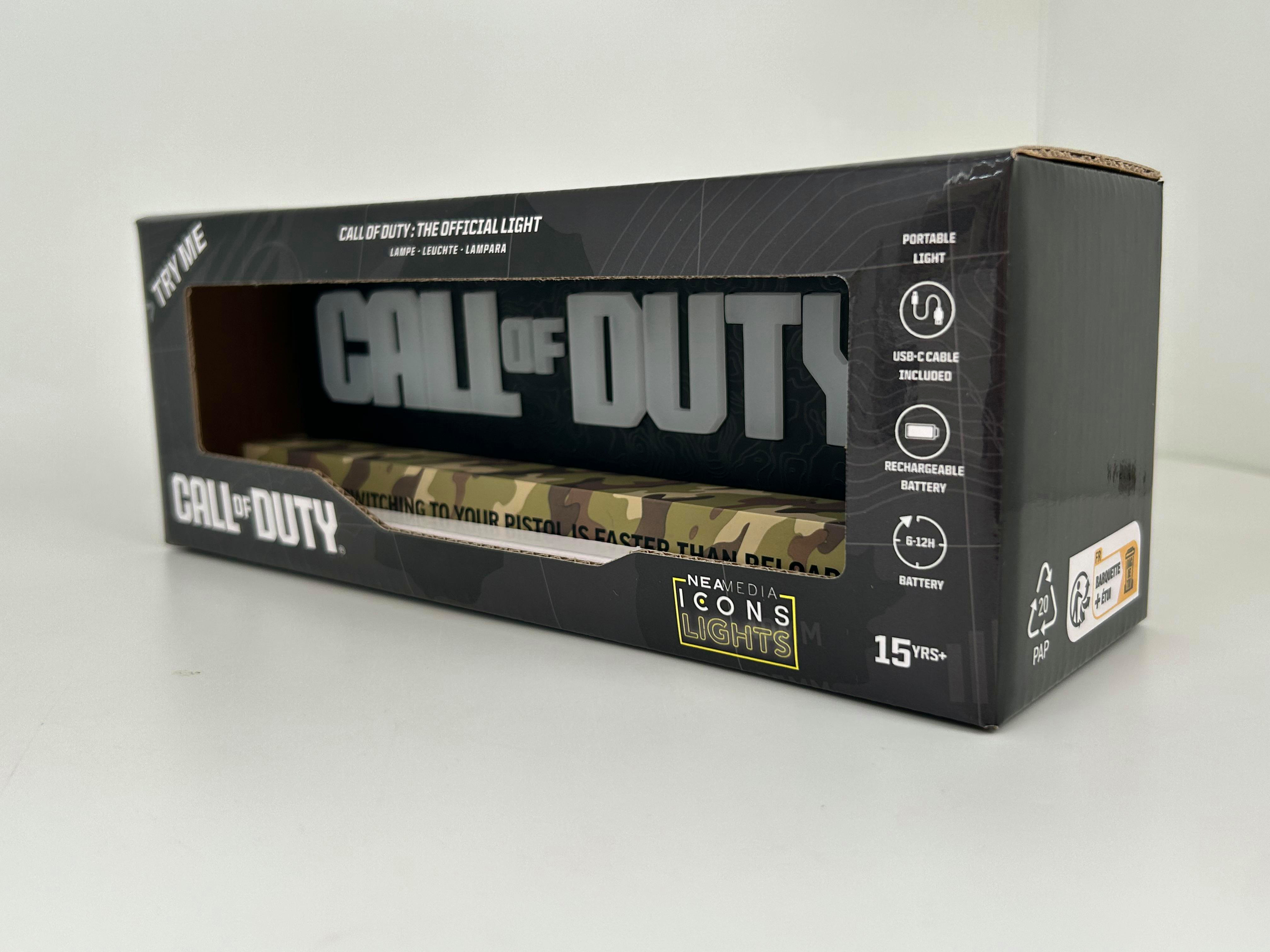 Karton mit "CALL OF DUTY" Logo, Text und einem Bild einer Lampe.