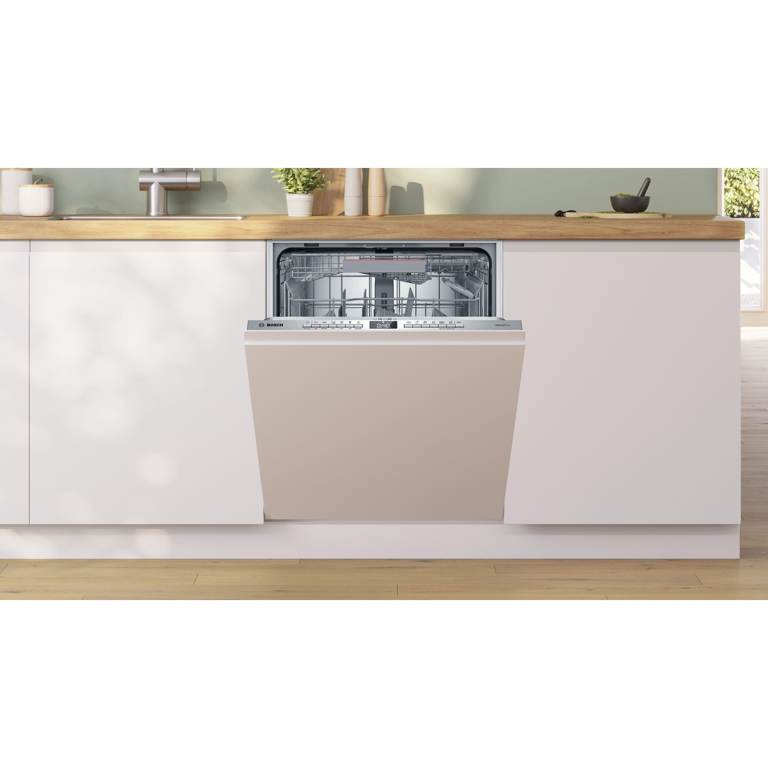 Una lavastoviglie completamente integrata in un mobile da cucina. Porta beige. Piano di lavoro e pareti bianche.