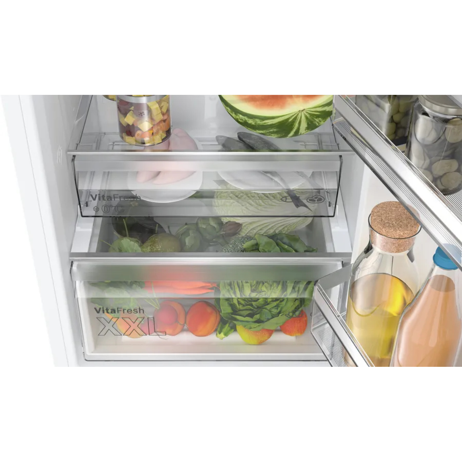 Refrigerator interior with fresh produce in drawers and jars with food.