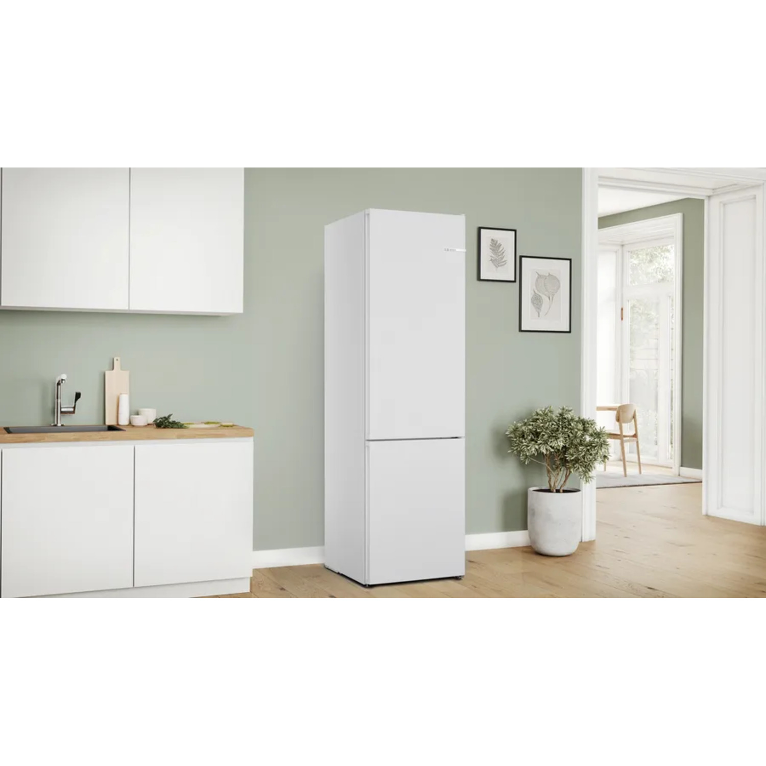 White refrigerator in a kitchen. Green wall and wooden floor.