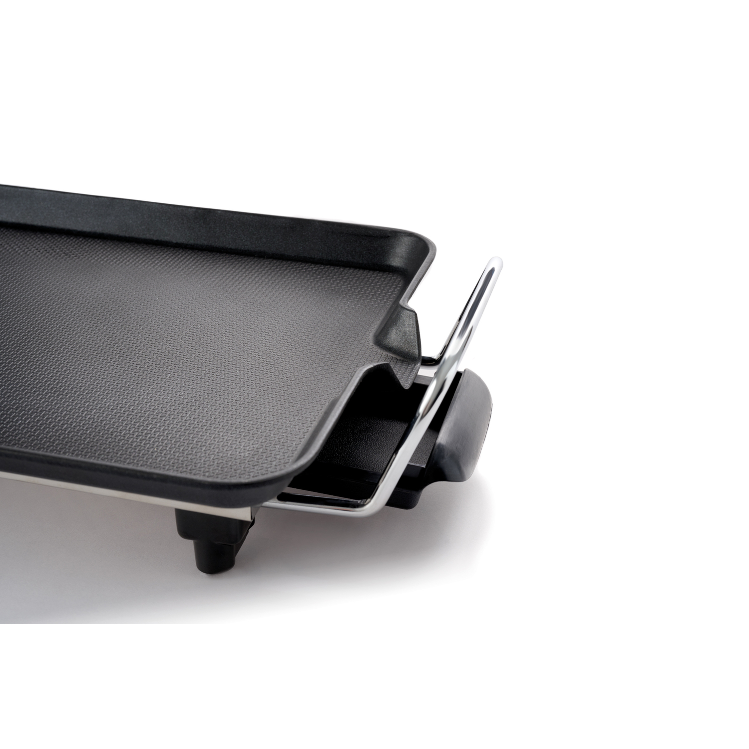Black electric grill, partially visible with the handle and drip tray.