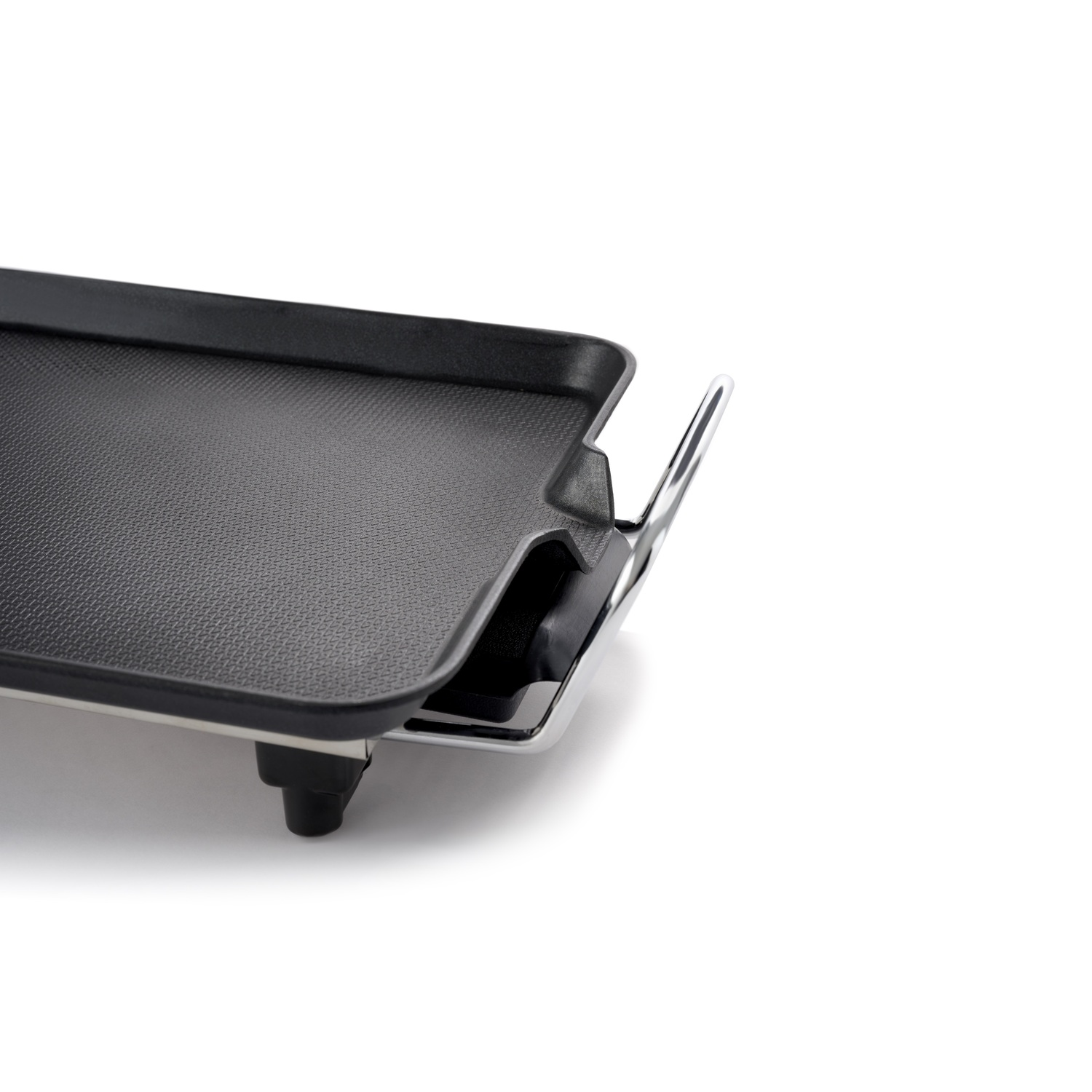 Black electric griddle with chrome handle, isolated on white background.