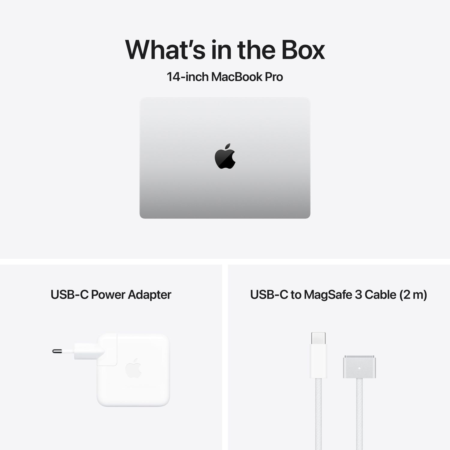 Un adaptateur secteur blanc, un câble et un ordinateur portable argenté fermé sur une surface blanche.