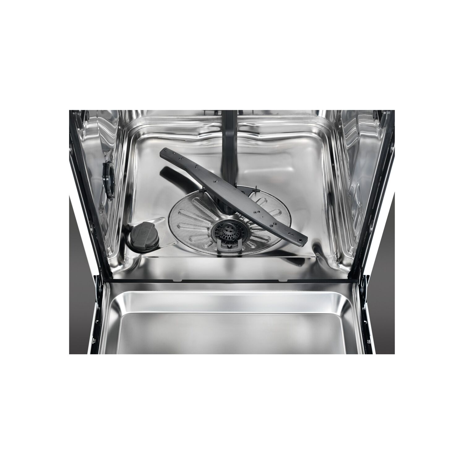 An open dishwasher, showing the interior: spray arm, filter, and bottom compartment.