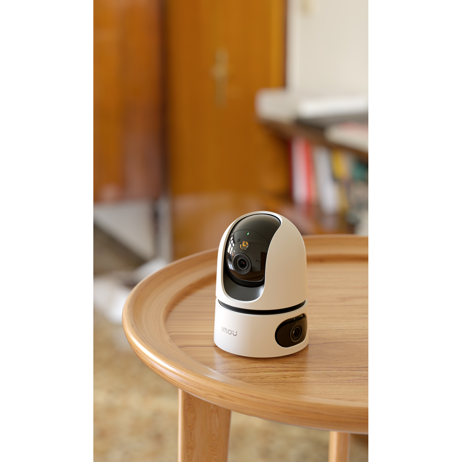 White and black security camera on a wooden table. Background is blurred. Door is in the background.