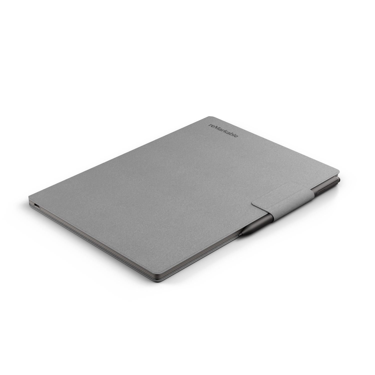 A grey reMarkable tablet with a pen lying on a black surface.
