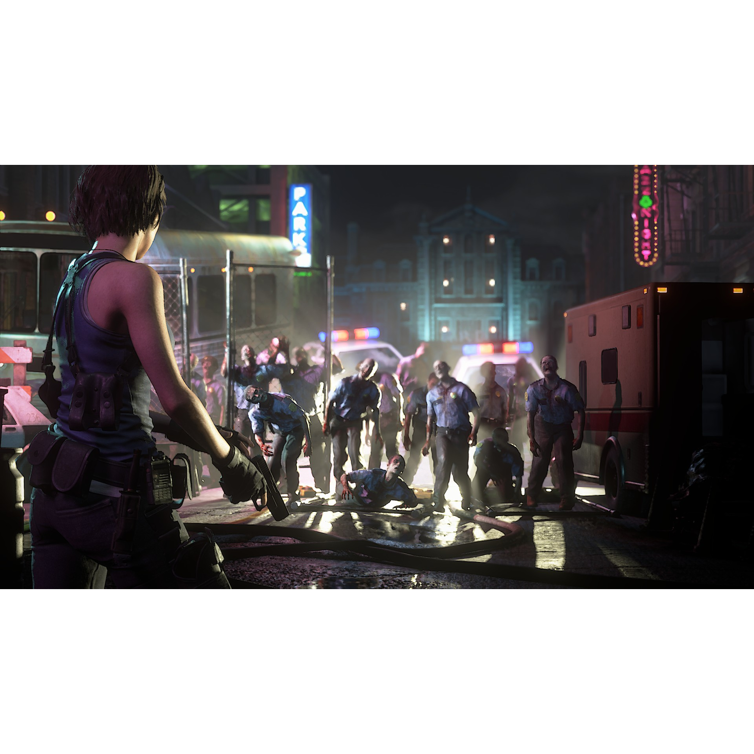 Woman with gun faces zombies in city street. Ambulance and police car are in the background.