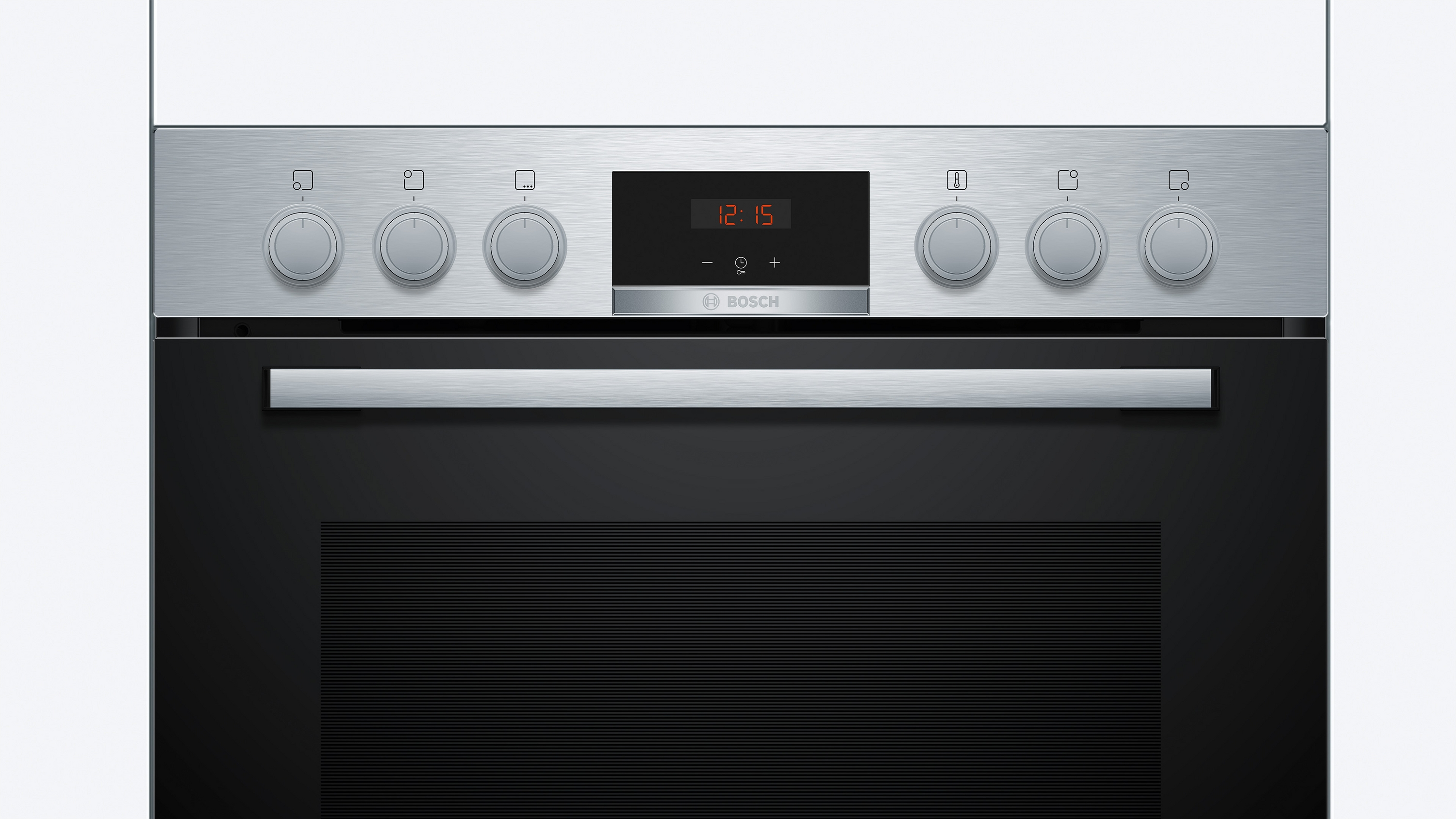 Ein Edelstahlbackofen mit Knöpfen und Digitalanzeige. Es hat eine dunkle Tür und ist in einer Küche.