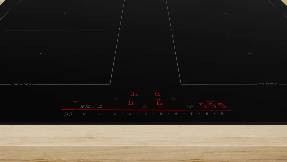 Czarna płyta indukcyjna z czerwonym wyświetlaczem cyfrowym pokazującym liczby i symbole.