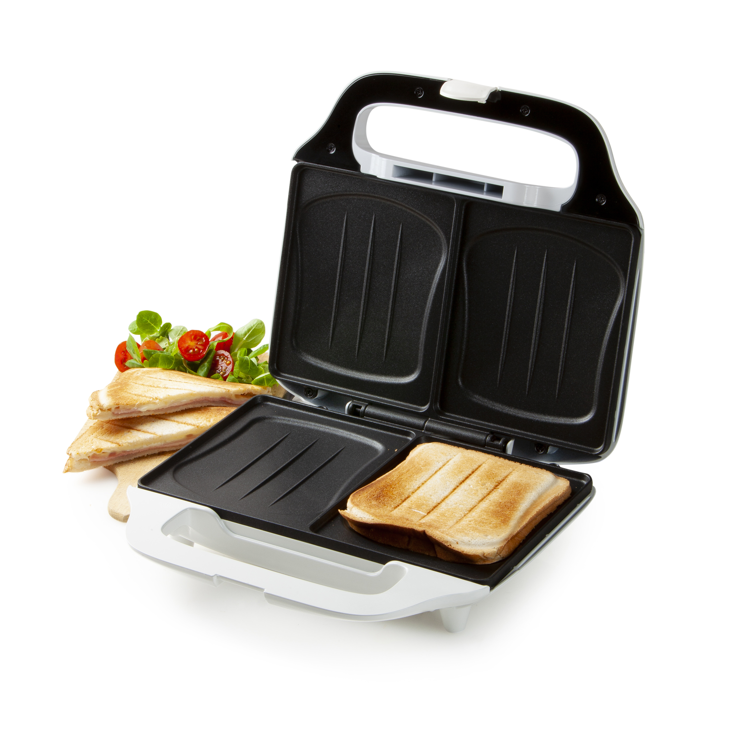 Open sandwich maker with two toasted sandwiches and salad ingredients.