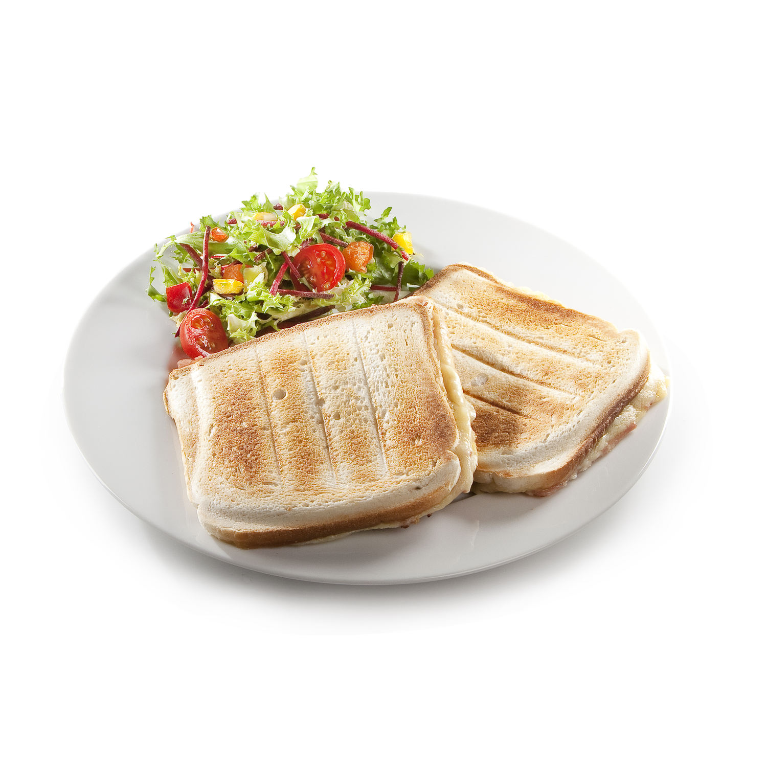 A plate with two toasted sandwiches and a side salad with tomatoes and greens.