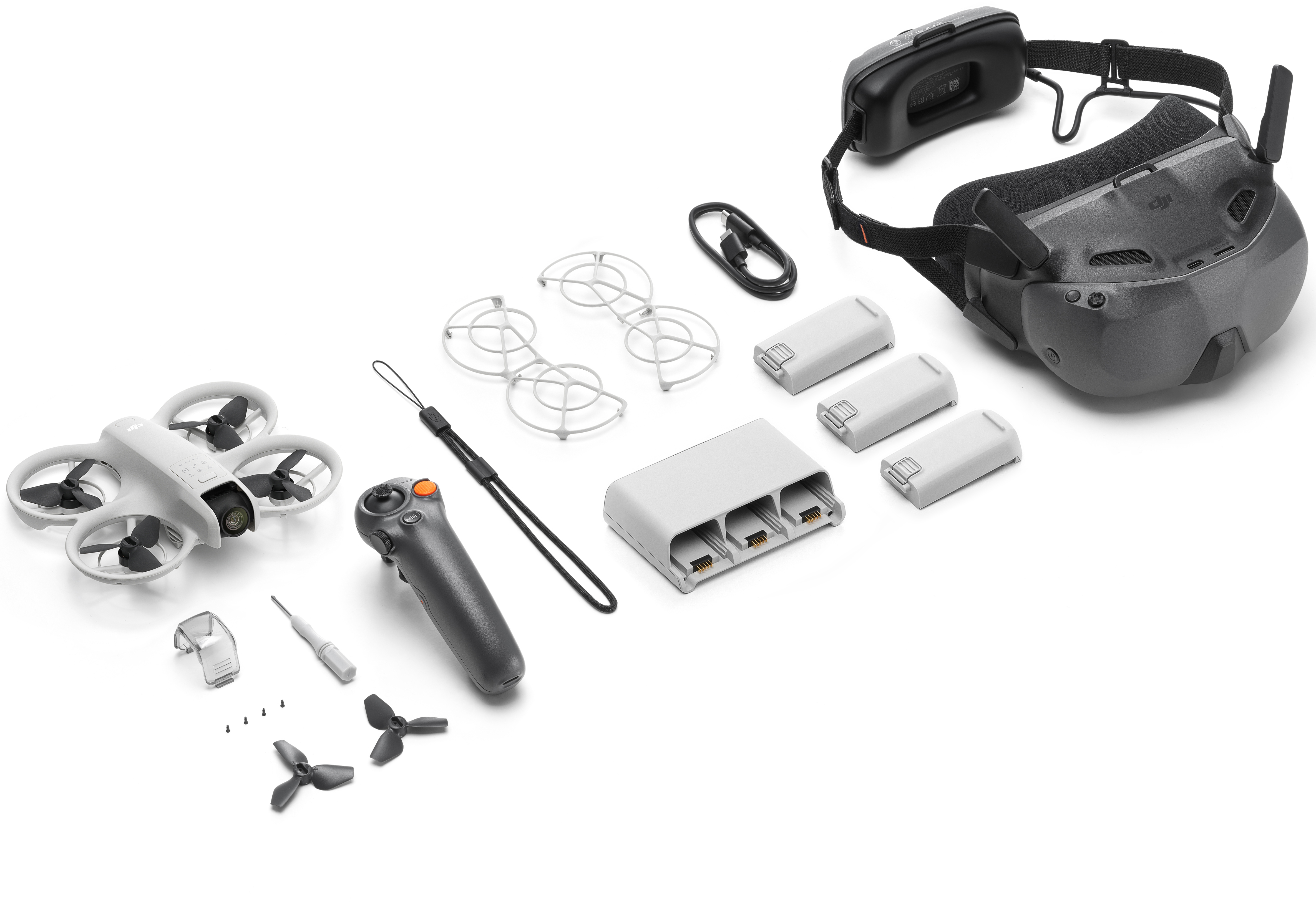 Un drone et ses accessoires sur une surface blanche. Drone, lunettes, contrôleur, etc.
