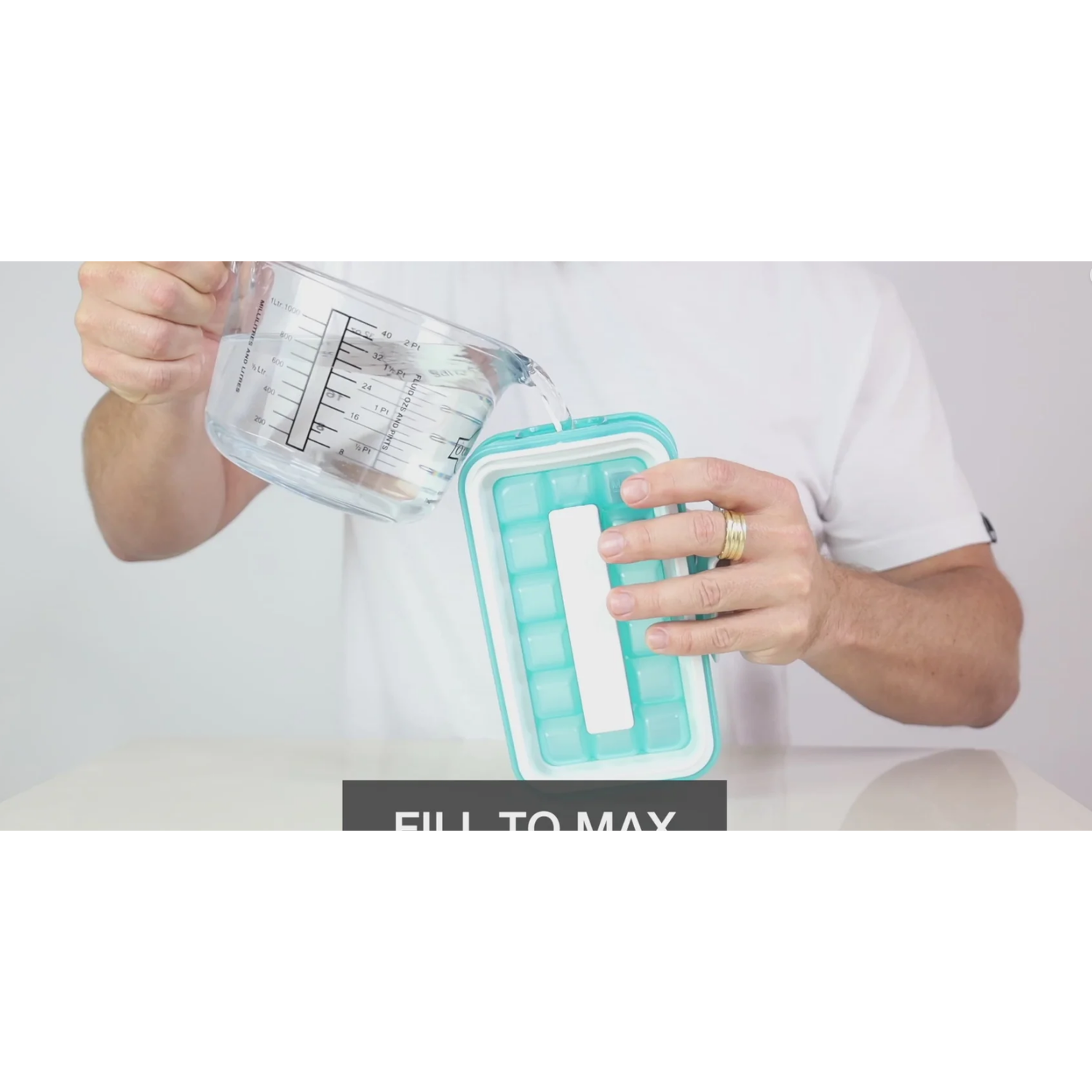 Person pouring water into a turquoise ice cube tray. Text says: FILL TO MAX.