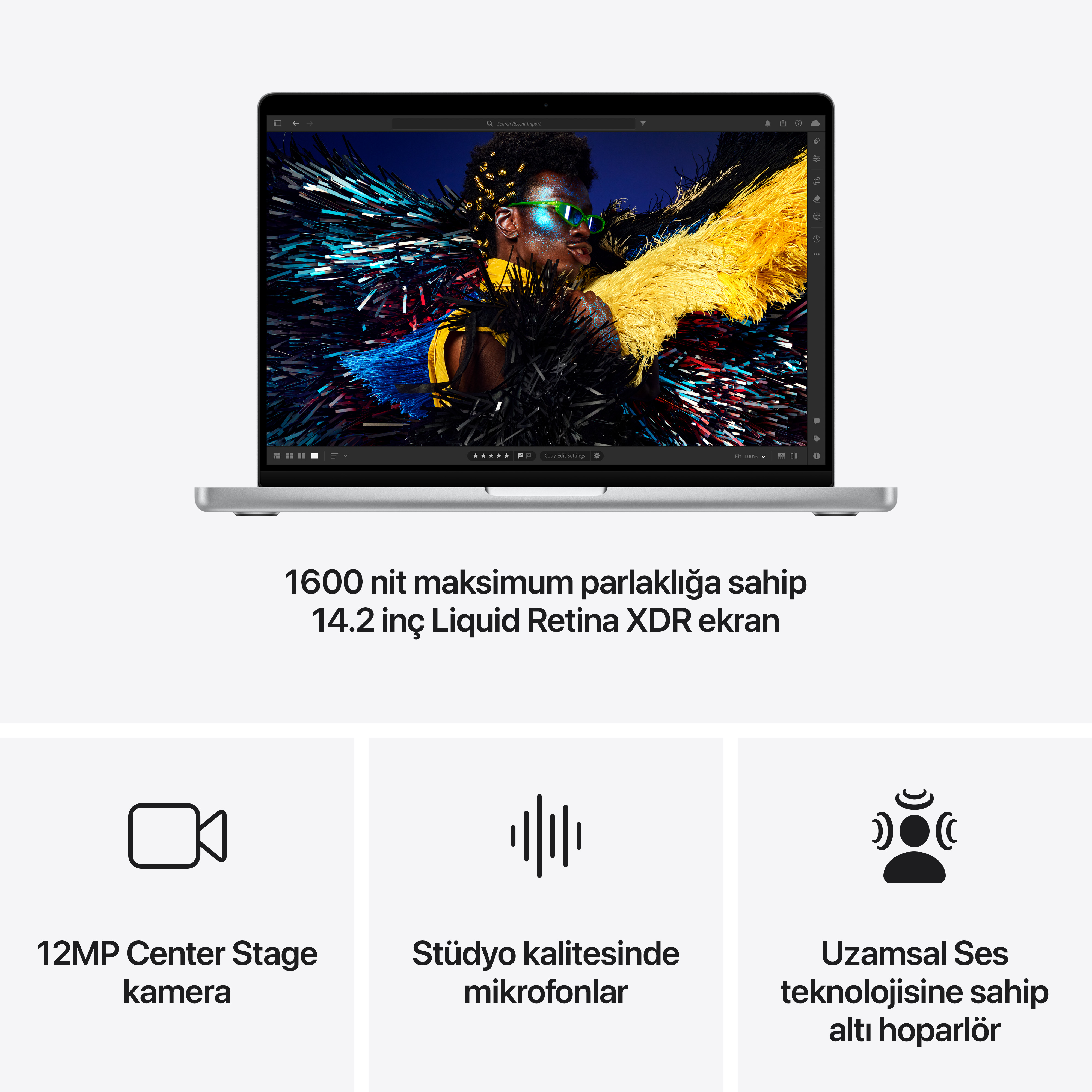 Gümüş laptop açık, ekranında bir fotoğraf ve bilgiler gösteriyor. Altında özellikler.